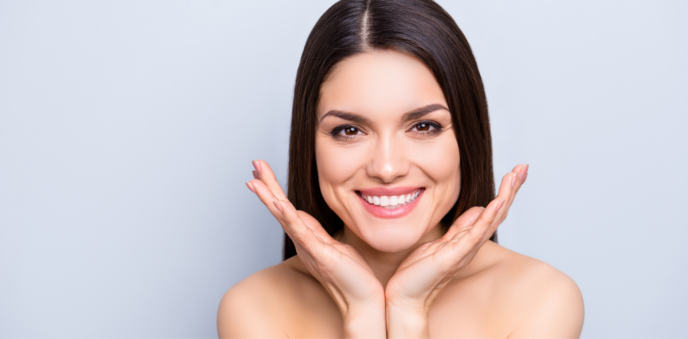 Woman with dark hair showing off her great skin